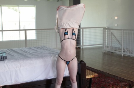 Foxy redhead Dolly Little stripping and playing with her pussy lips