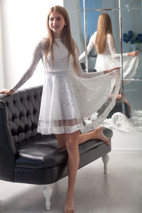 Young looking girl Rina takes off her pretty dress to model totally naked