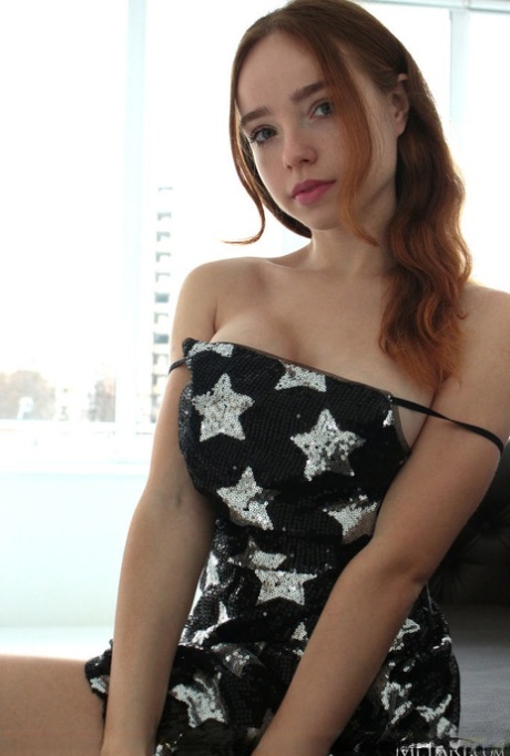 Sweet redheaded teen Rinna Ly unveils her great tits while getting naked