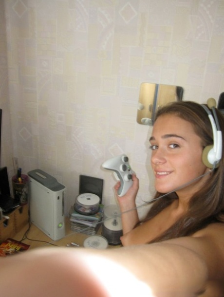 Hot gamer girl poses naked and teases with her cute titties in a solo