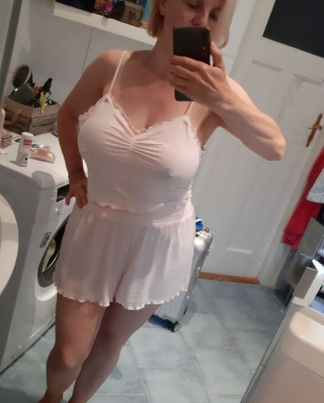 Beautiful mature amateur shows her hot curves while drinking a morning coffee