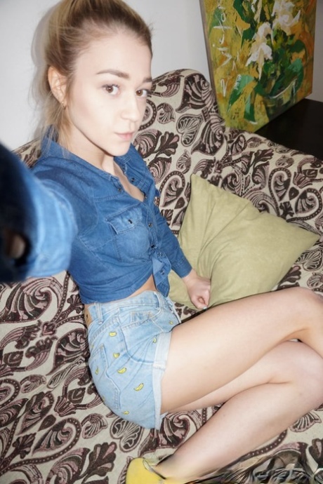 Blonde young amateur in glasses sheds her clothes and takes sexy selfies