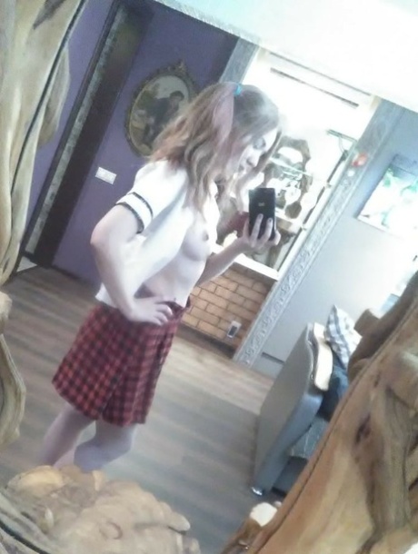 Cute redheaded amateur exposes her sweet nips and poses in a solo