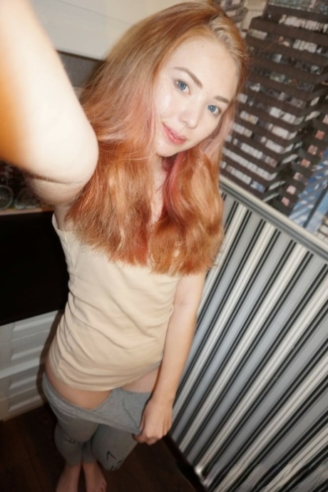 Cute redheaded amateur exposes her sweet nips and poses in a solo