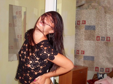 Brunette amateur Viktoria strips to a thong during indoor solo action