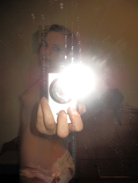 Sensational teen takes hot selfies while posing naked in her living room