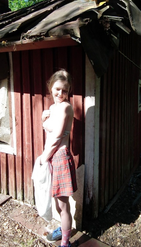 Solo girl shows her tits and twat while forcing entry into abandoned cabin