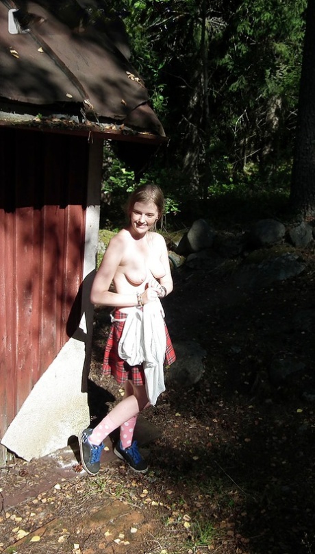 Solo girl shows her tits and twat while forcing entry into abandoned cabin
