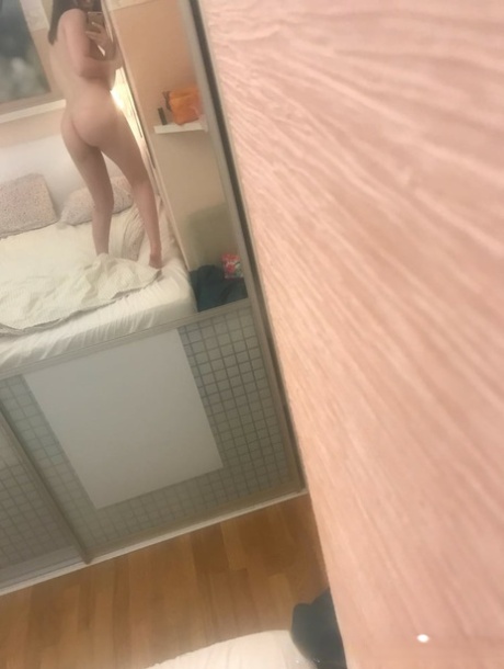 Brunette babe in glasses takes nudes showing her small tits & her shaved twat