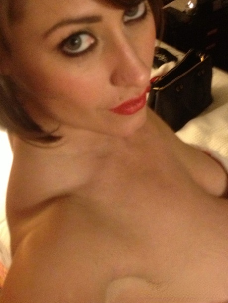 Cougar Eva Notty poses in her Xmas outfit before getting her huge tits jizzed