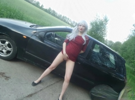 Sensational blonde babe flaunts her incredible big booty in front of a car