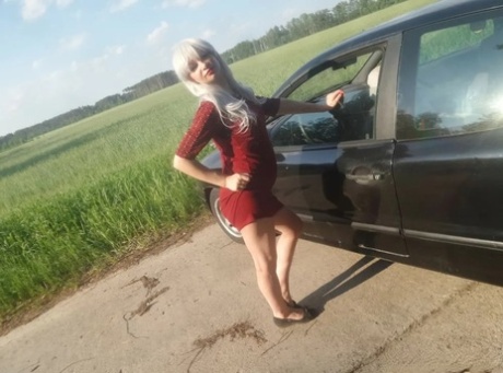 Sensational blonde babe flaunts her incredible big booty in front of a car