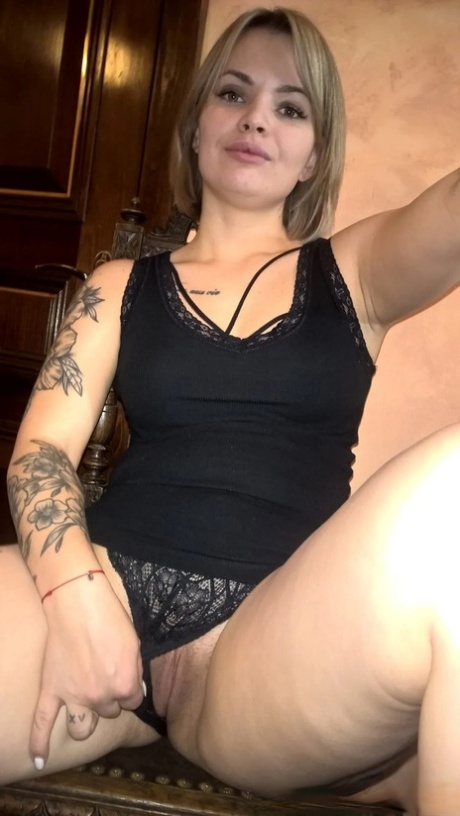 Blonde babe shows her small tits & her shaved pussy in black lingerie