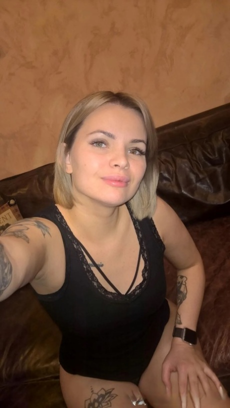 Blonde babe shows her small tits & her shaved pussy in black lingerie