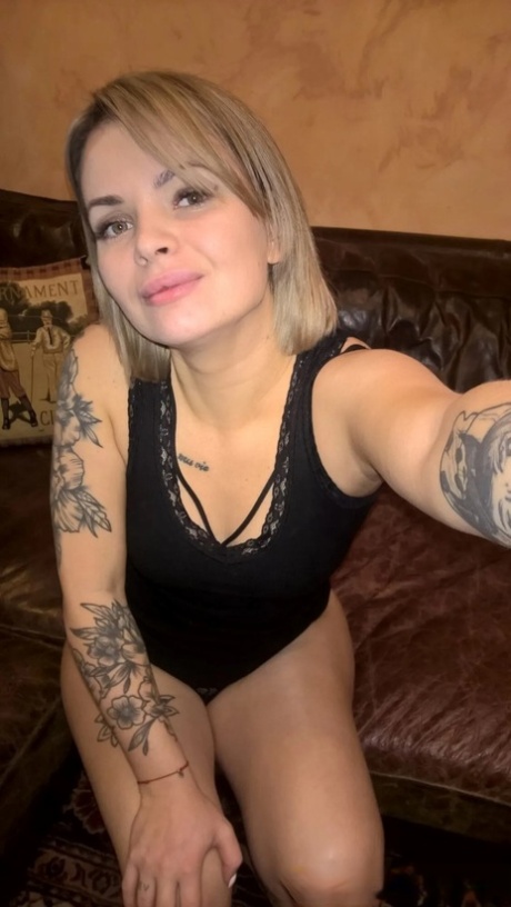 Blonde babe shows her small tits & her shaved pussy in black lingerie