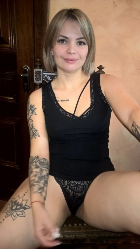 Blonde babe shows her small tits & her shaved pussy in black lingerie