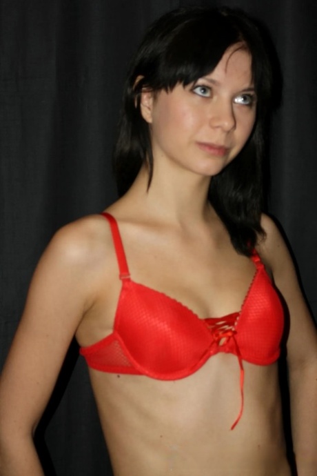 Dark-haired amateur exposes her skinny body and poses naked around the house