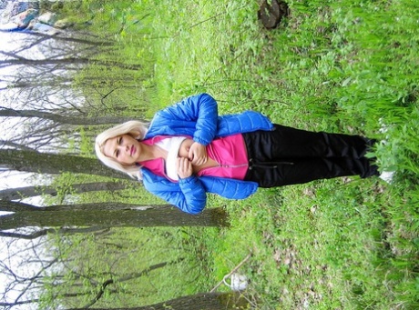 Blonde amateur Adele exposes her boobs and butt while in a forest setting