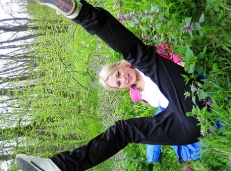 Blonde amateur Adele exposes her boobs and butt while in a forest setting