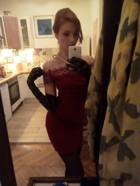 Young redhead Radka takes clothed and topless selfies around her place