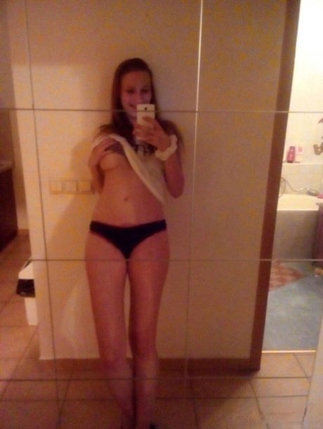 Young redhead Radka takes clothed and topless selfies around her place