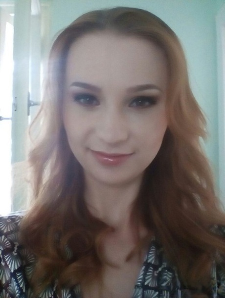 Young redhead Radka takes clothed and topless selfies around her place