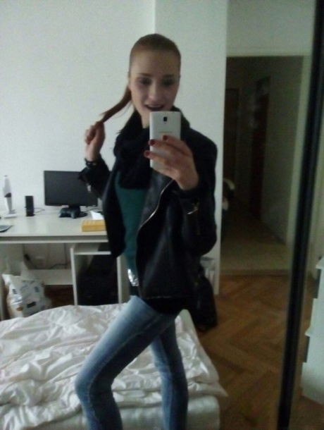 Young redhead Radka takes clothed and topless selfies around her place
