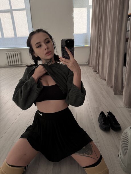 Brunette teen Beatrice Bell shows her tongue while wearing knee socks