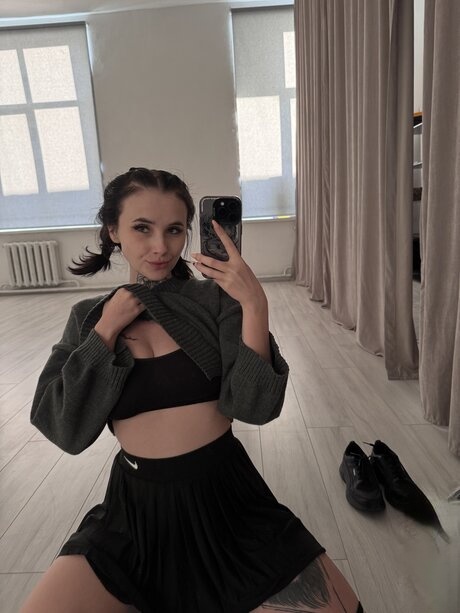 Brunette teen Beatrice Bell shows her tongue while wearing knee socks