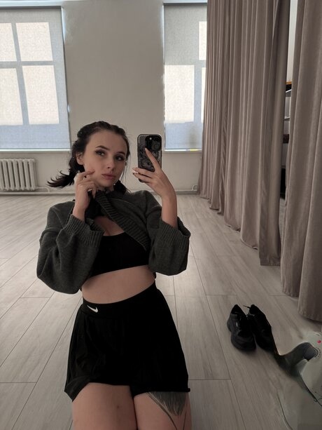 Brunette teen Beatrice Bell shows her tongue while wearing knee socks