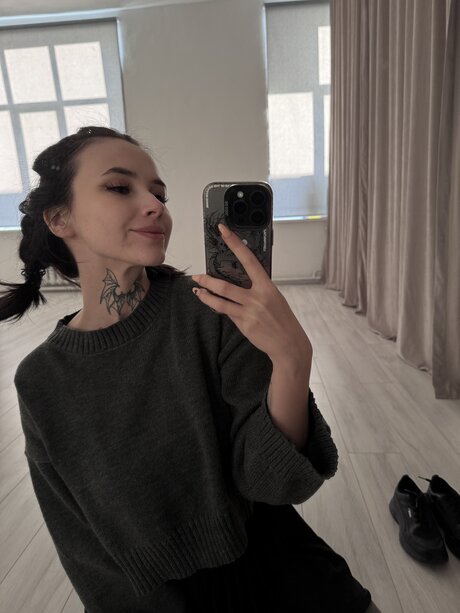 Brunette teen Beatrice Bell shows her tongue while wearing knee socks