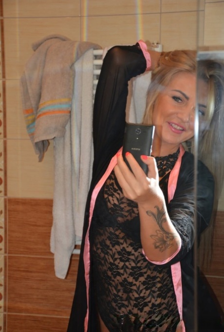 Blonde amateur takes nude selfies showing her tiny tits & her bald cunt