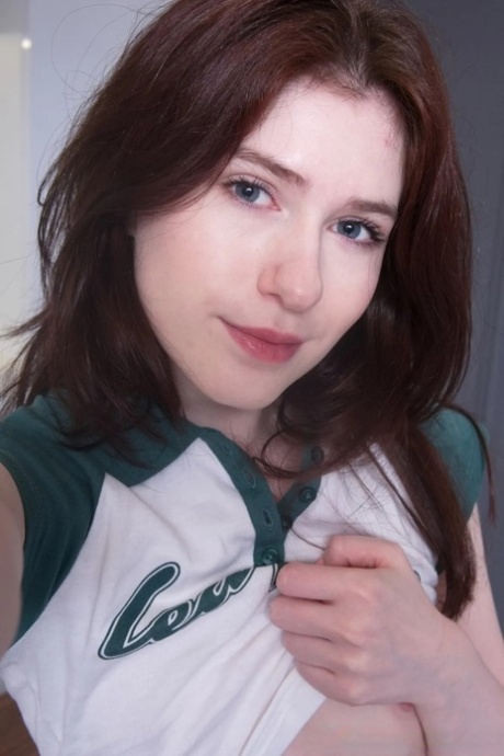 Brunette amateur shows her small titties and takes sexy selfies