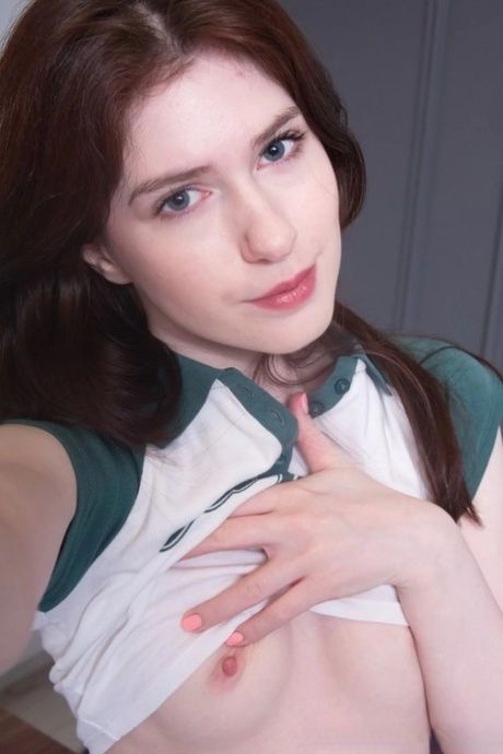 Brunette amateur shows her small titties and takes sexy selfies