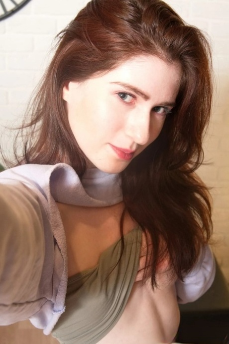 Brunette amateur shows her small titties and takes sexy selfies