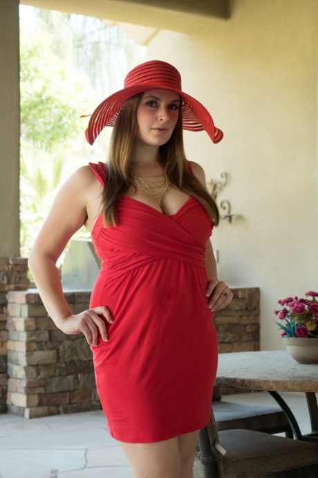 Solo model Danielle changes into a sun hat and dress before toying her twat