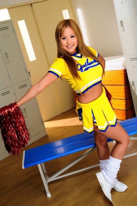 Adorable Japanese cheerleader uncovers great tits before showing her pussy