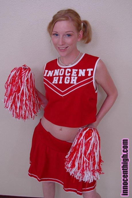 Pigtailed cheerleader Alexa Lynn flashes tiny natural tits and panties