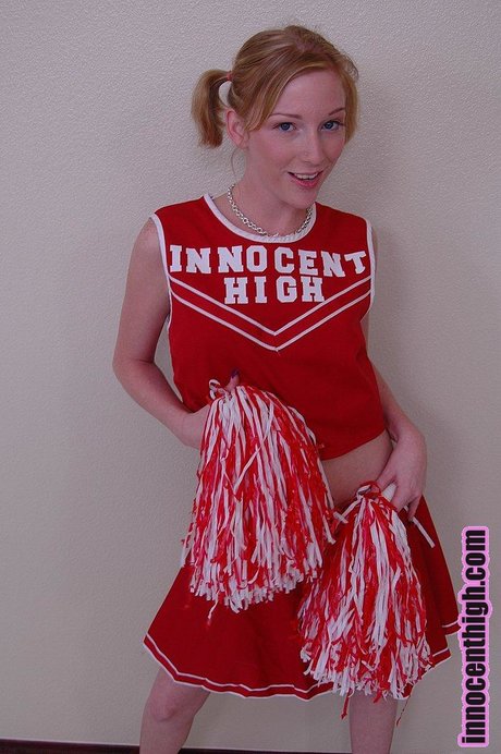 Pigtailed cheerleader Alexa Lynn flashes tiny natural tits and panties