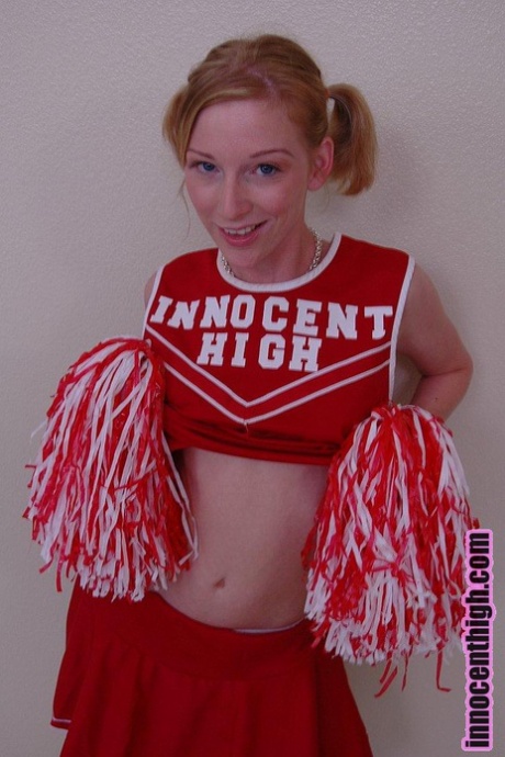 Pigtailed cheerleader Alexa Lynn flashes tiny natural tits and panties