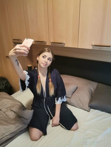 Russian babe Julia Red spreads her shaved pink pussy up close on a couch