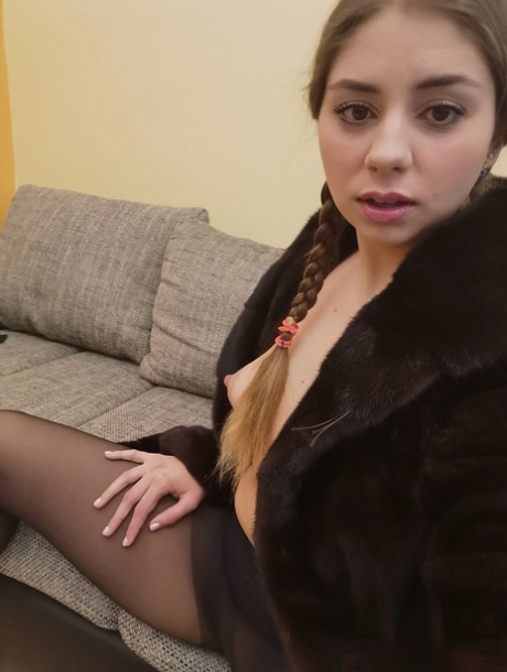 Russian babe Julia Red spreads her shaved pink pussy up close on a couch