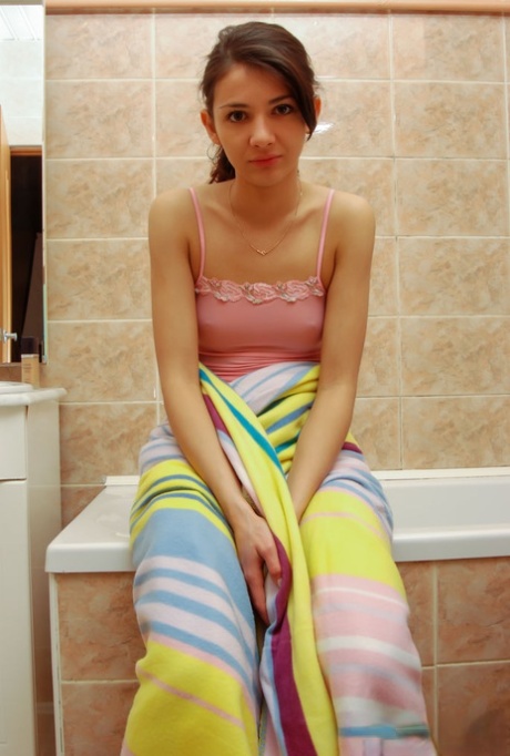 18-year-old girl Dena covers her naked body in baby oil