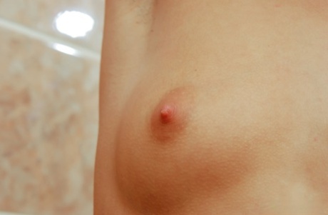 18-year-old girl Dena covers her naked body in baby oil