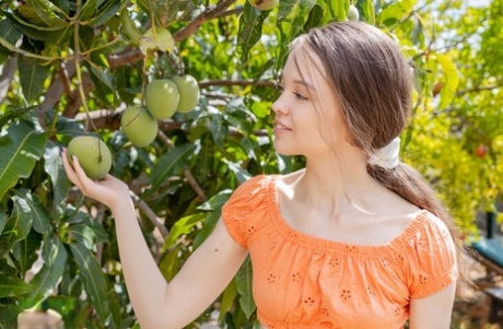 Young looking girl Shea picks ripe fruit before getting butt naked