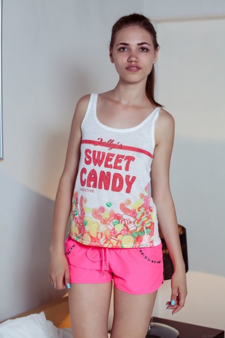 Cute teen Jasmina eats an ice-cream and strips to pose on a bed