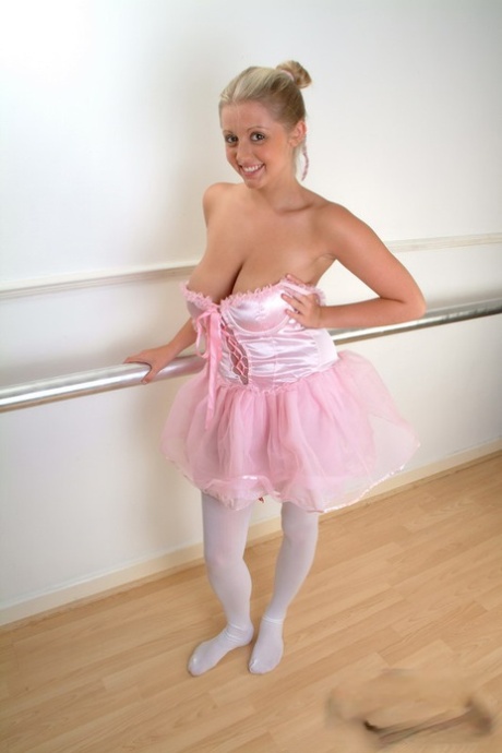 Blonde amateur Emily Brady holds her big boobs in hands during SFW action