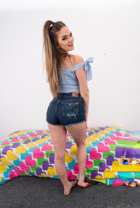 Ponytailed babe Athena Faris shows off her big ass & her lickable shaved pussy