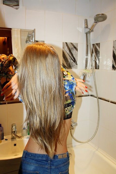 Slim amateur uncovers her small tits in blue jeans during homemade action