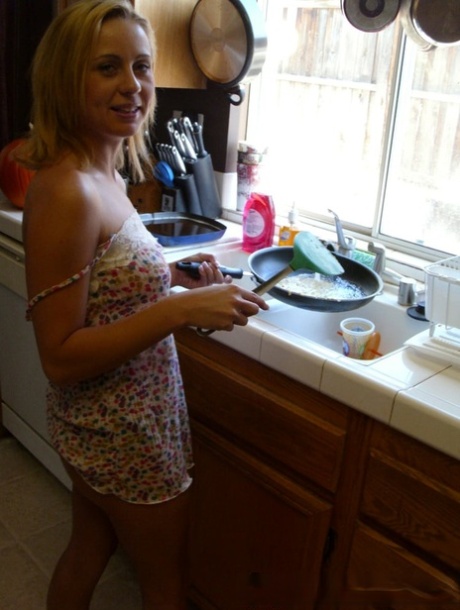 Pretty amateur wife Katty West strips and shows her big tits while cooking